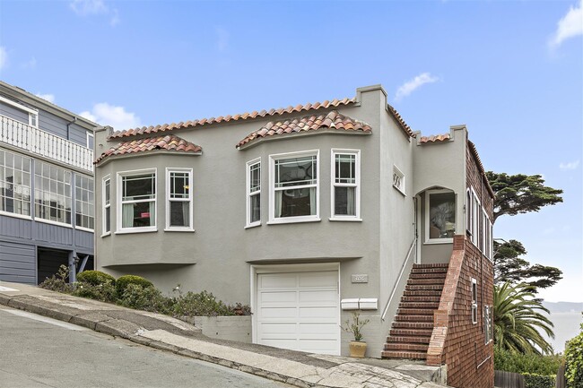 Front of house with driveway on side