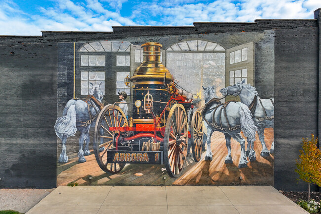 Aurora town center has historic paintings on the street walls.