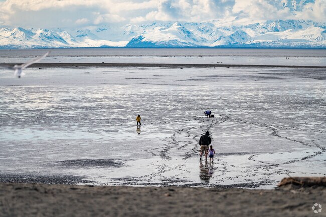 A family enjoys playing out on the flats at Kasilof River Special Use Area near Kalifornsky.