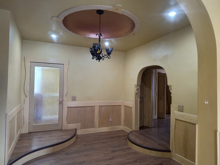 Dramatic foyer with domed ceiling and wainscotting.