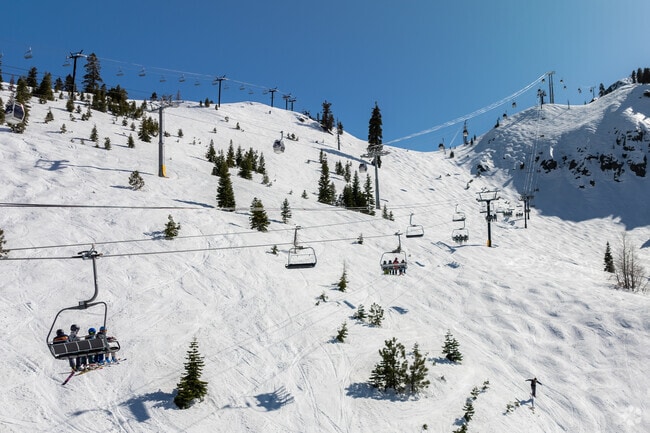 Skiers and Snowboarders head up the famous KT-22 at Palisades Tahoe in Alpine Meadows.