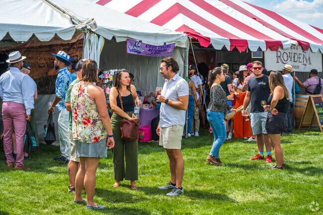 Friends enjoy a beautiful day at the Harvest Wine & Music Festival, held each summer near Academy Acres North.