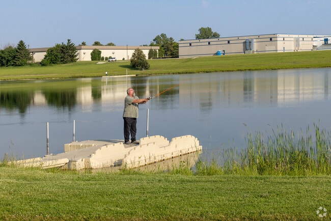 A man casts a line into the peaceful waters of Babe Mann Park.