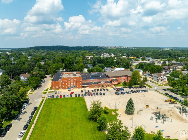 Central School campus with parking lot and playground on a sunny day in Lake Geneva.