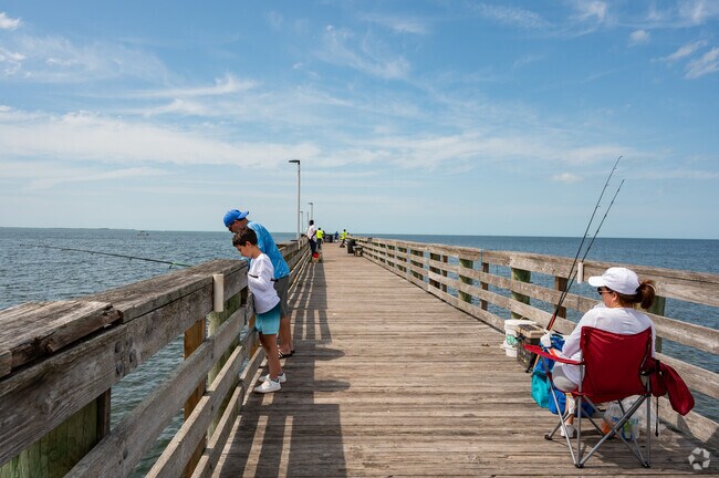 A family enjoys time together on the Fishing Pier at Anclote Gulf Park.
