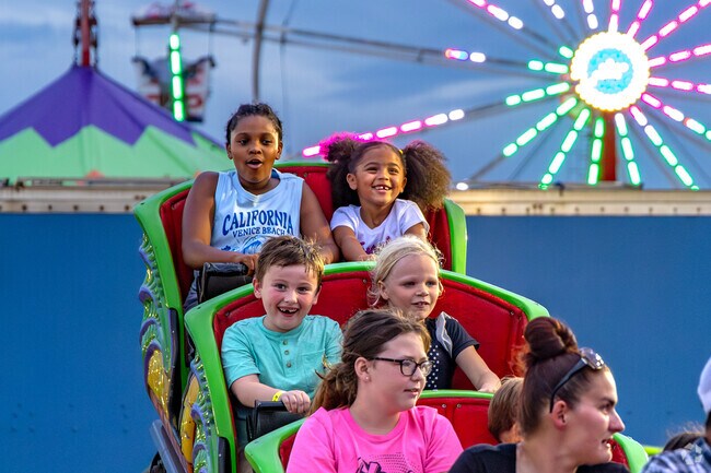 Festival goers enjoy carnival rides and games at the Bourbon County Fair.