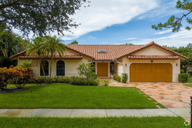 Boca West ranch style home with covered garage.
