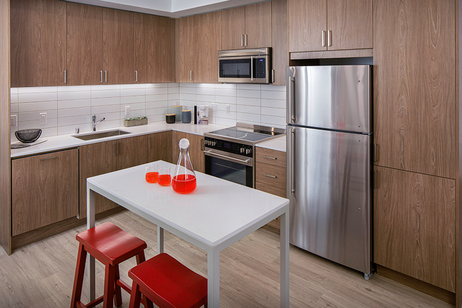 Our kitchens feature stainless steel appliances, tile backsplash and wood-grain cabinets