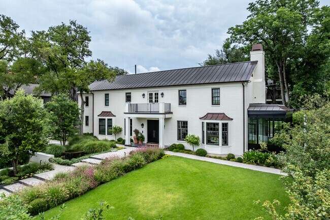 This Georgian mansion offers a beautiful, landscaped yard and a sunroom off the side in Old Enfield.
