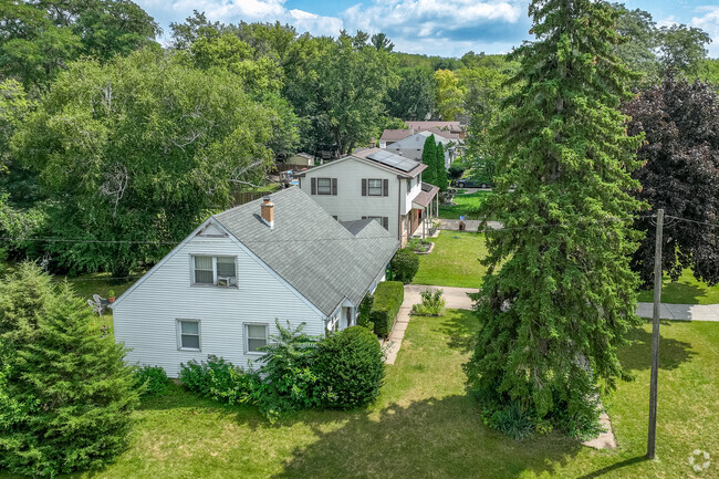 Rows of homes are hidden behind tall pine trees for privacy in Forest Hills View.