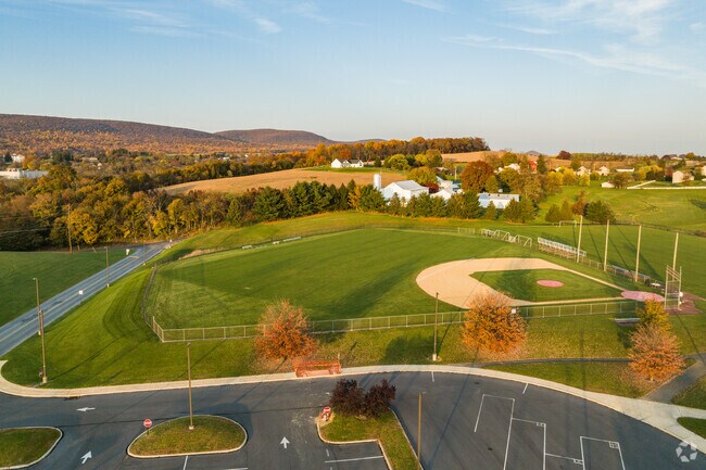A picturesque baseball field in Hamburg, PA, bathed in the warm hues of sunset.