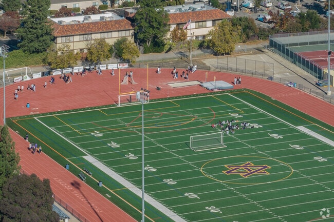 Amador Valley High School students run around the modern sports field in Stoneridge.