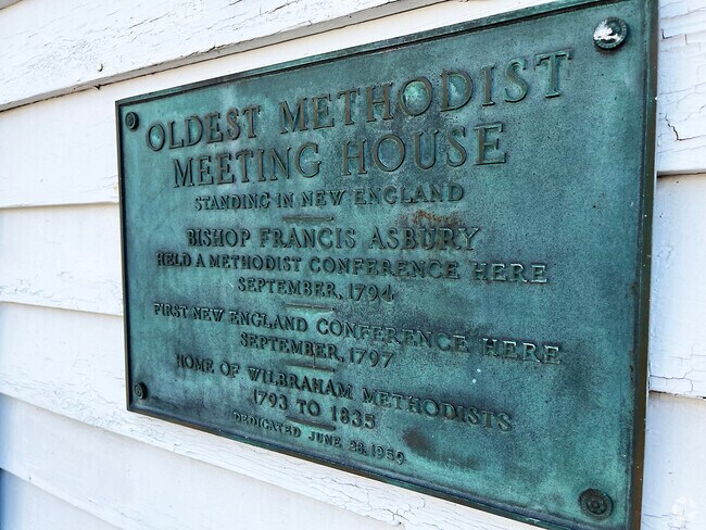 The plaque at the Old Meeting House symbolizes the collection and preservation of Wilbraham's local history and culture.