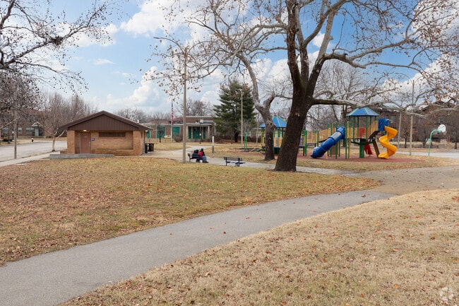Residents enjoy looking at the city skyline from the benches of Loretta Hall Park.