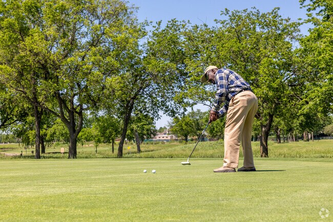 Golfers practice their shots on the Battlecreek golf course.