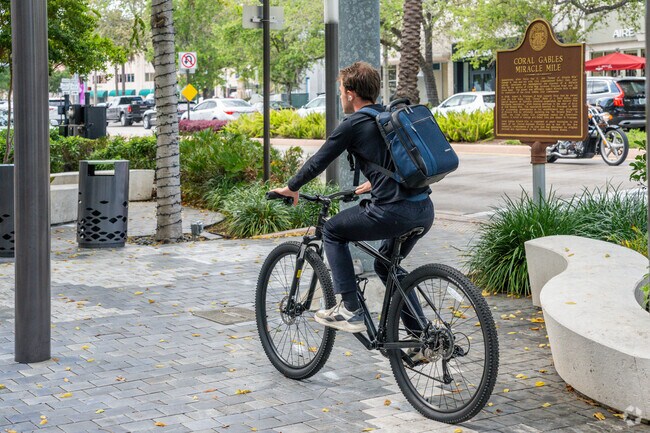 Biking along Miracle Mile in Downtown Gables offers a scenic ride through tree-lined streets and vibrant storefronts.
