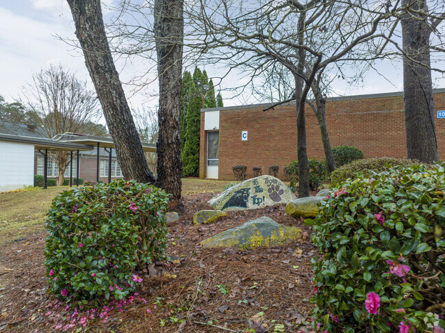 School boulder in green space area at Turning Point Academy.