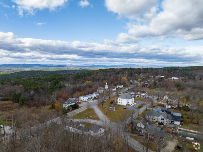 An aerial view of Dunbarton reveals rolling hills, quaint homes & scenic New England landscapes.