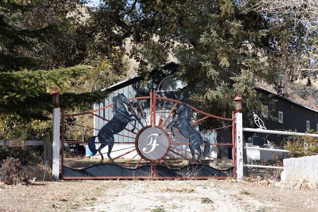 Custom metal gate adorned with horse motifs, welcoming you to a ranch in Lebec.