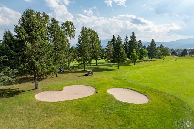 Larchmont Golf Course, a par-72 course surrounded by mountains.