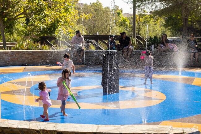 Kids are enjoying a hot summer day playing in the fountains at Sunset Park in Palomar Estates.