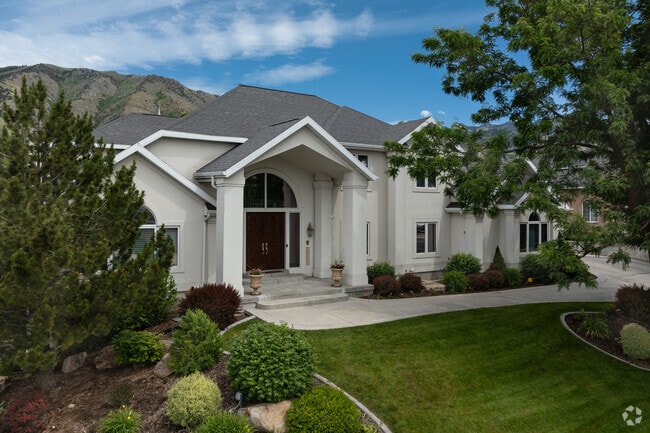 Palatial homes with grand entrances and yards located at the base of the mountains in Hillcrest.