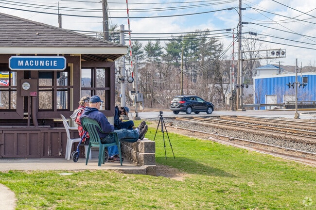 Locals in Lower Macungie Township West sit at the Macungie train stop to watch trains pass.