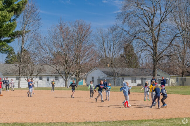 At Oak Park in Reedsburg, families enjoy playing baseball.