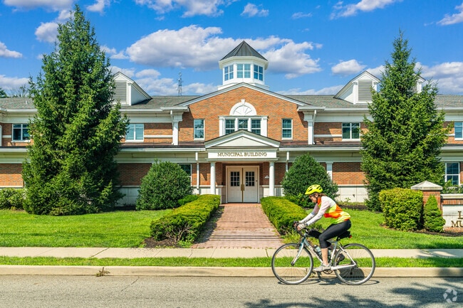 A cyclist enjoys a ride past the Municipal Building in Lincoln Park.