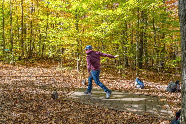 A person throws a disc from the first tee at the Quarry Disc Golf Course near South Barre.