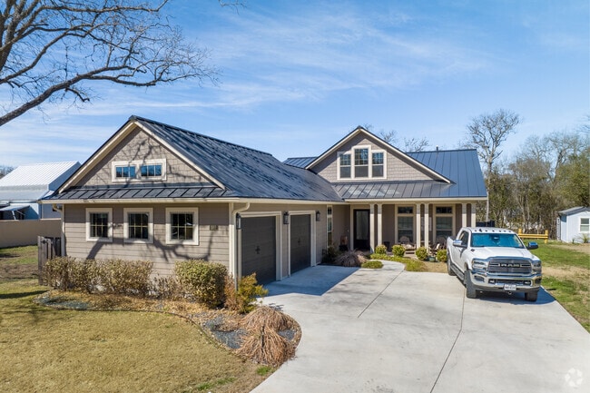 A large traditional ranch style home with a two car garage can be found in Boerne.