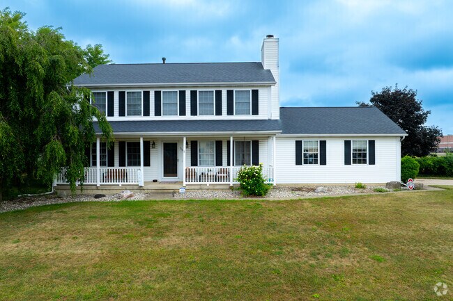 Gridded streets feature homes with leafy lawns, gardens, mature trees, and large front porches.