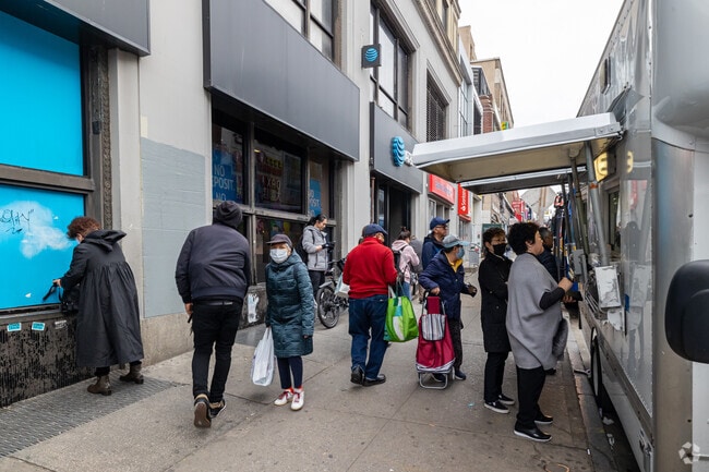 People line up for a food truck in Downtown Flushing, Queens.