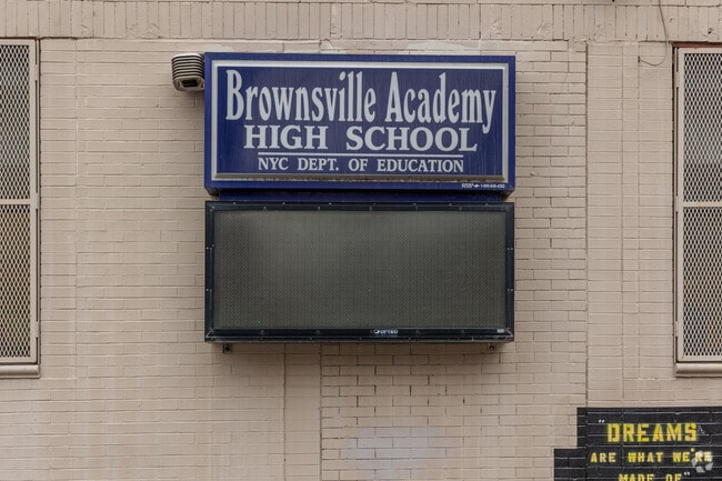 Signage for the building where the New Visions Aim Charter High School is.