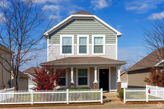 The unique roof shape adds character to this two-story Versailles home.