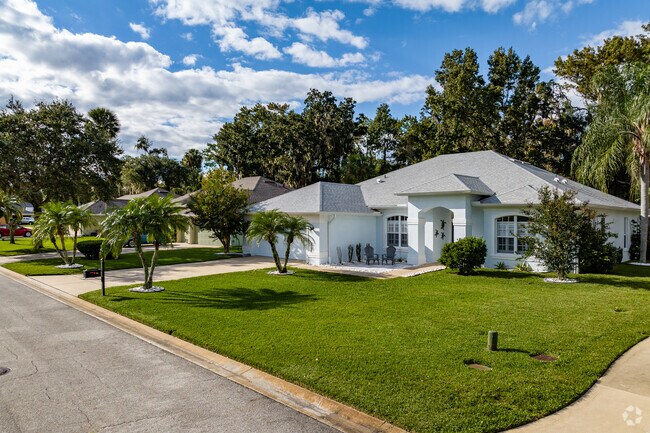 A row of modern ranch-style homes with attached garages in Ormond Lakes.