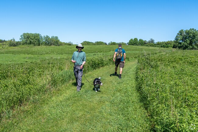 A man takes a dog for a walk on the trails in Baker's Lake Nature Preserve in South Barrington.