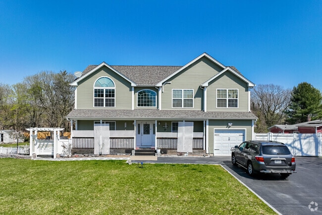 This colonial-inspired bi-level in North Bay Shore has a beautiful front porch.