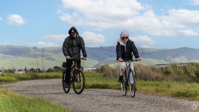 A couple enjoys a scenic bike ride around Eden Landing, embracing Glen Eden's beauty.