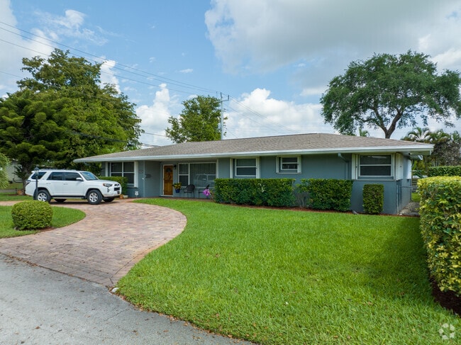 House in Hollywood Pines with a pristine front lawn and driveway.