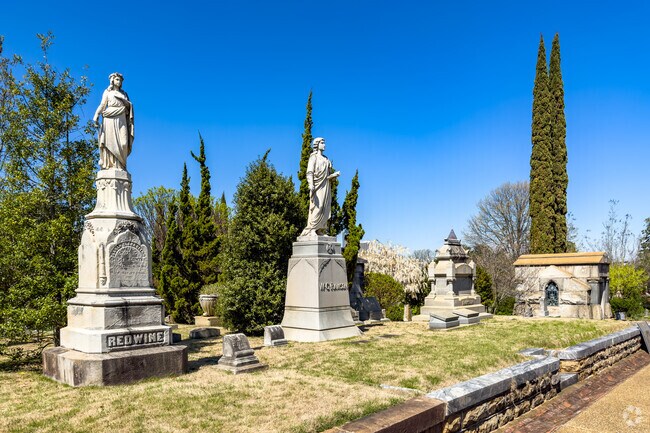 Large sculptures in Oakland Cemetery watch over gravesites.