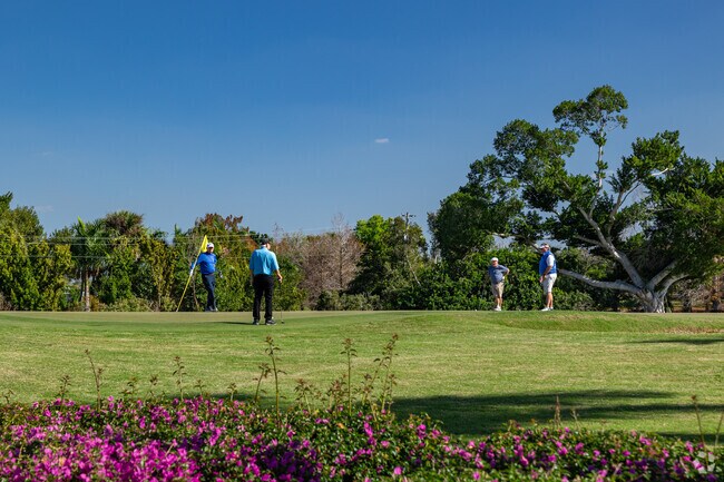 Golfers play rounds with friends at the beautiful Cypress Lake Golf Club.