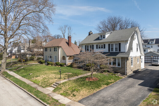 Along Cornell Avenue in Waverly, a Dutch Colonial home shares frontage with its neighbor sporting a porch Hacienda-style arches.