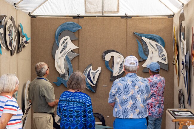 Art Lovers enjoy admiring the handmade pieces at The Fort Myers Arts Fest held near Fort Myers Shores.