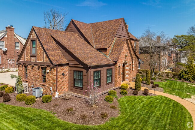 Large brown brick and stone home on a neatly manicured lot in Glendale