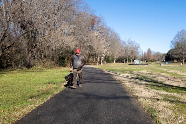 Person walking with his dog in Forest Hill Park.