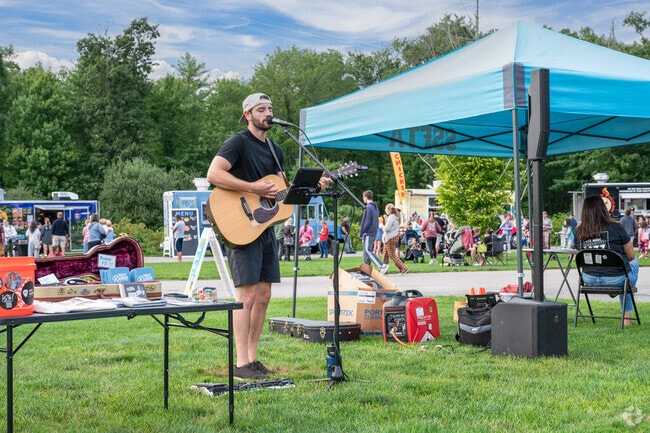 Enjoy live music while you relax in the grass of Forge Pond Park.