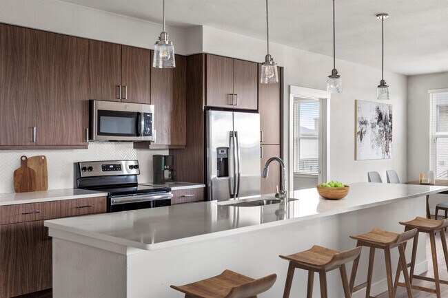 Gourmet Kitchen with Stainless Steel Appliances and Pendant Lighting