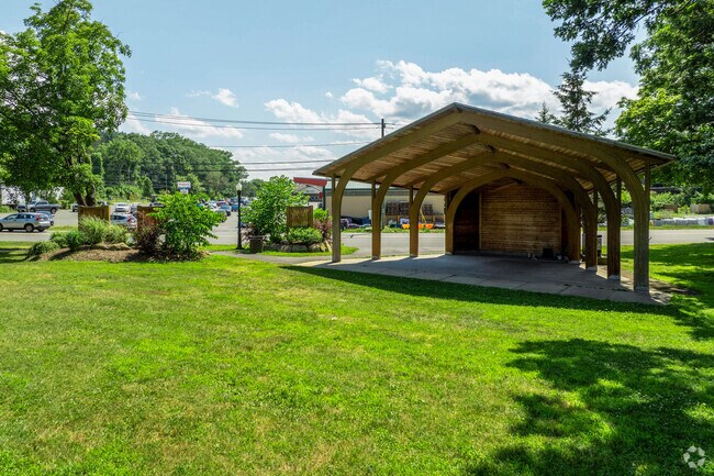 Peseomskut Park in Turners Falls has a large green area with tree coverage, benches, playground and concert shell.