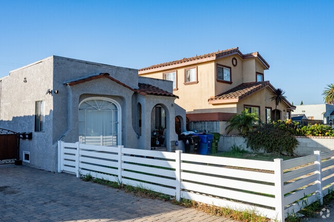 Fenced front-yards complement Spanish-style homes in Harbor City neighborhoods.